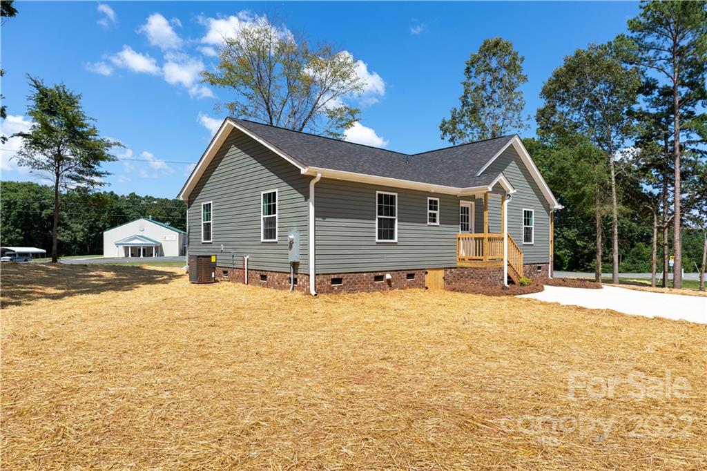 6184 Hopewell Road Hickory Grove, SC 29717 - Photo 6 of 30 a front view of a house with a yard covered with snow