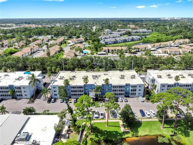 an aerial view of residential houses with outdoor space and lake view