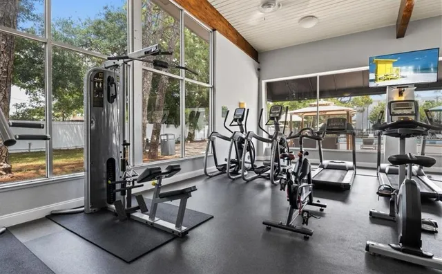 a view of a swimming pool with a lawn chairs under an umbrella