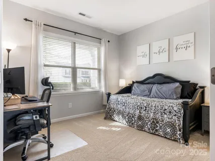 a bedroom with a bed and a desk