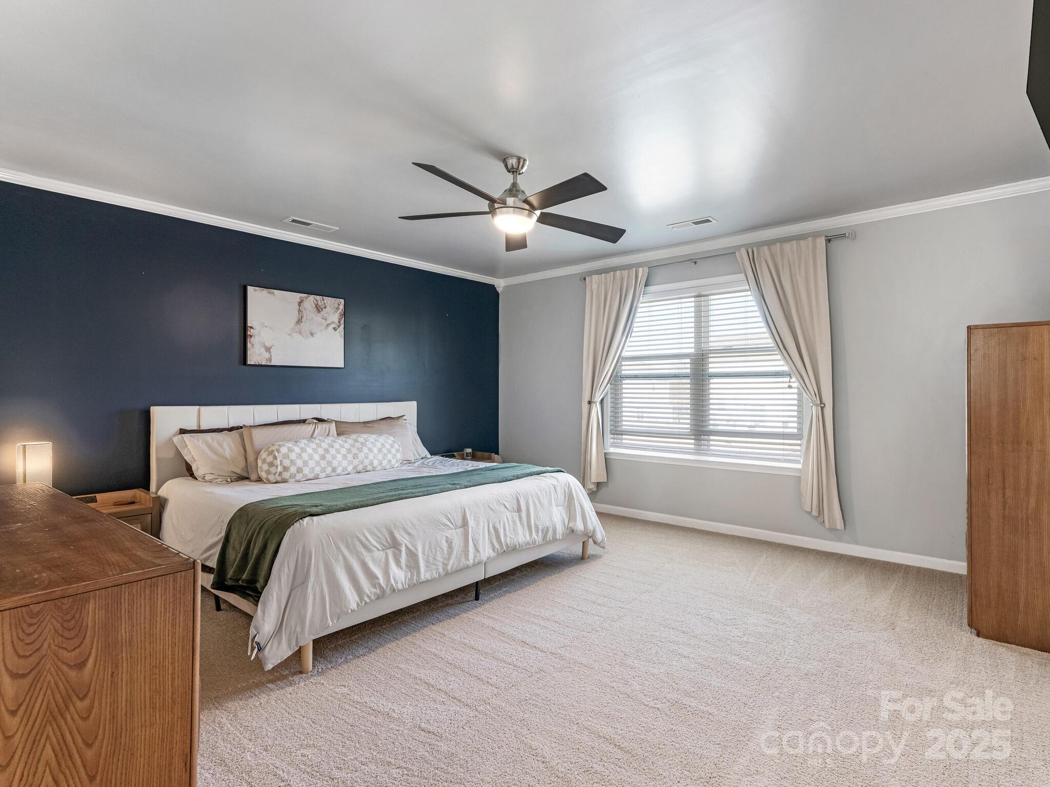 13118 Great Laurel Road Charlotte, NC 28227 - Photo 19 of 38 a spacious bedroom with a bed and a large window