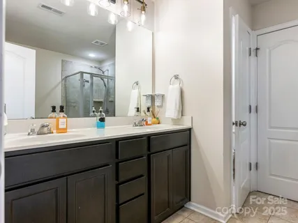 a bathroom with a sink double vanity and a mirror