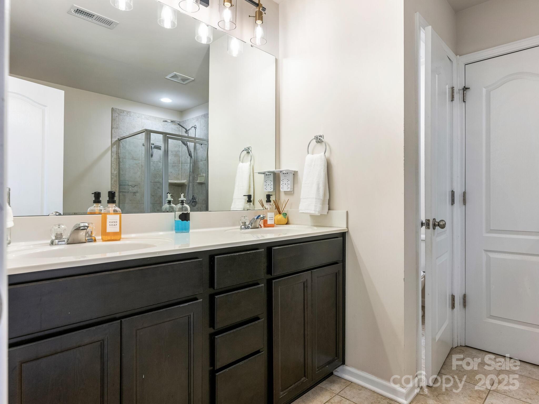 13118 Great Laurel Road Charlotte, NC 28227 - Photo 21 of 38 a bathroom with a sink double vanity and a mirror