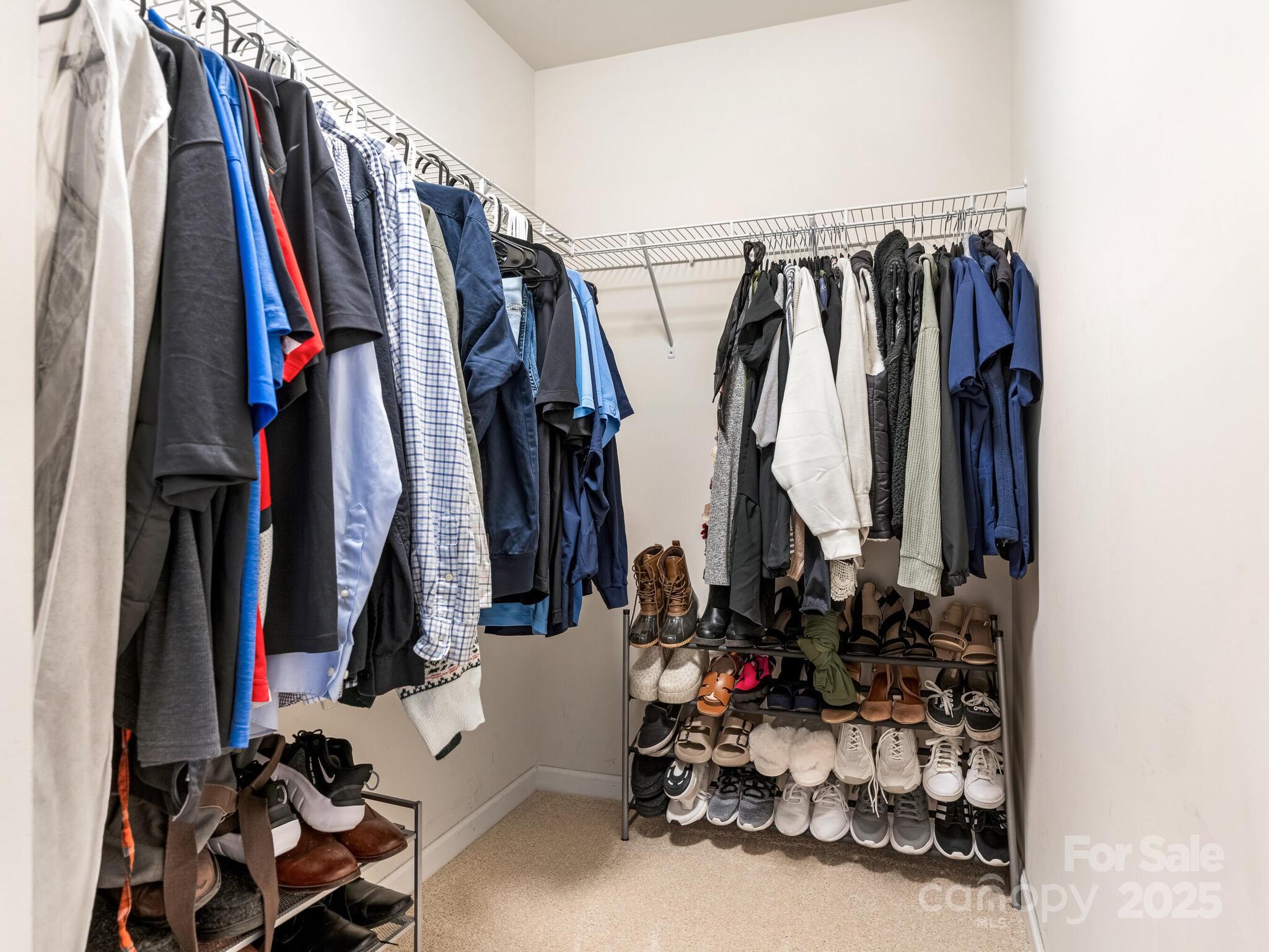 13118 Great Laurel Road Charlotte, NC 28227 - Photo 23 of 38 a view of walk in closet with clothes and shoes