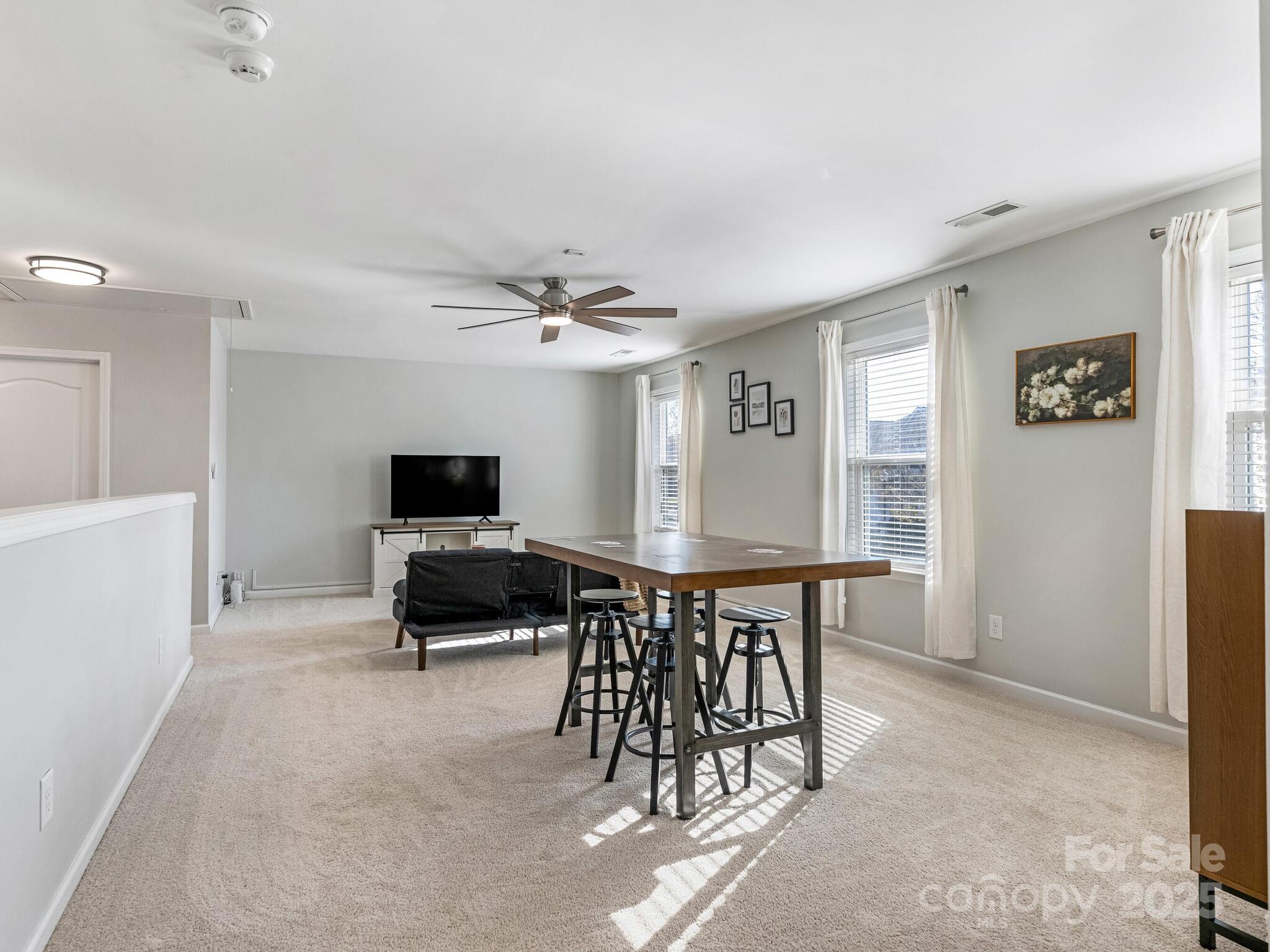 13118 Great Laurel Road Charlotte, NC 28227 - Photo 25 of 38 a living room with furniture and a flat screen tv