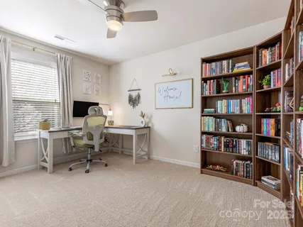 a view of a workspace with a bookshelf