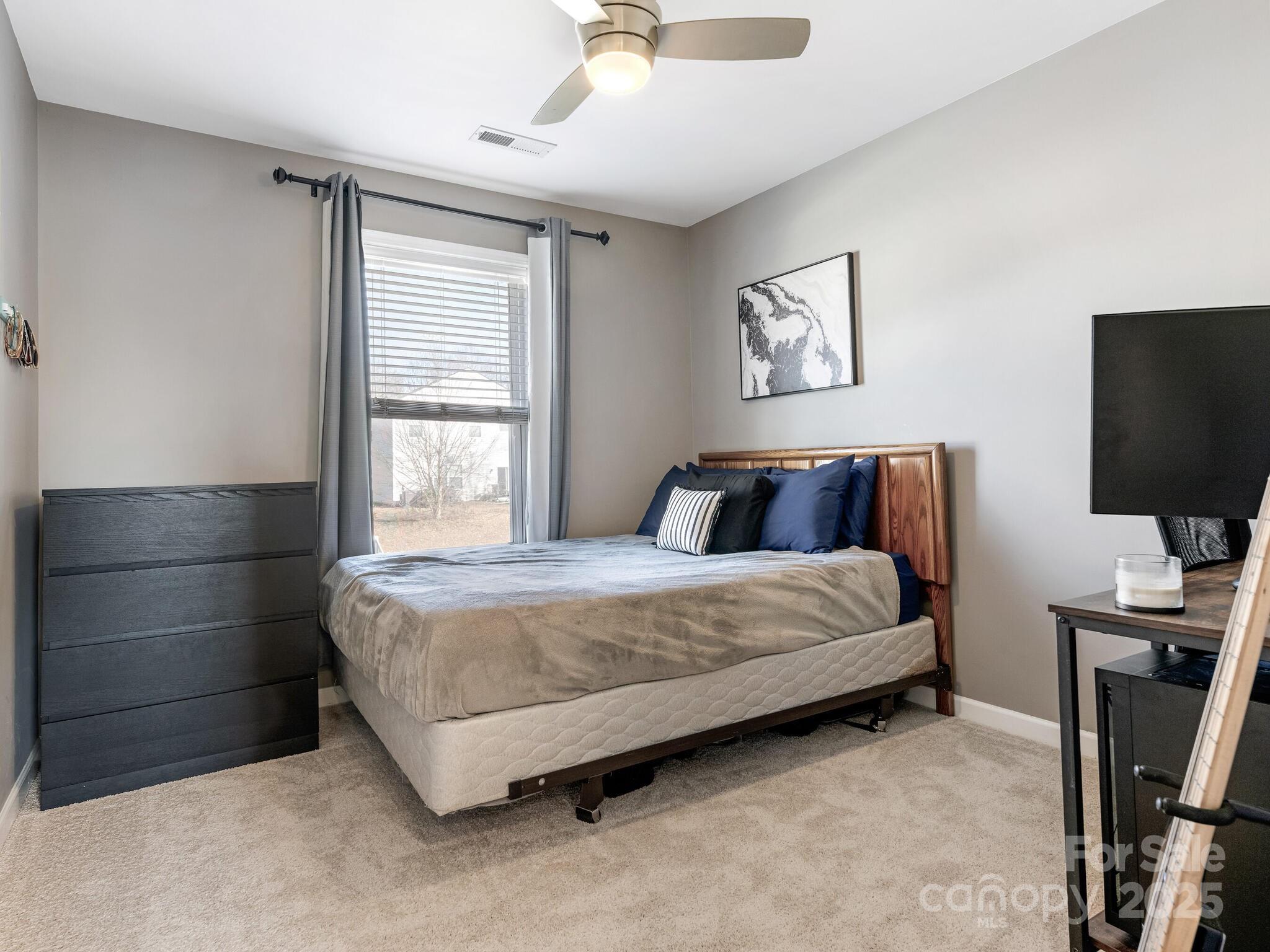 13118 Great Laurel Road Charlotte, NC 28227 - Photo 28 of 38 a bedroom with a bed and flat screen tv