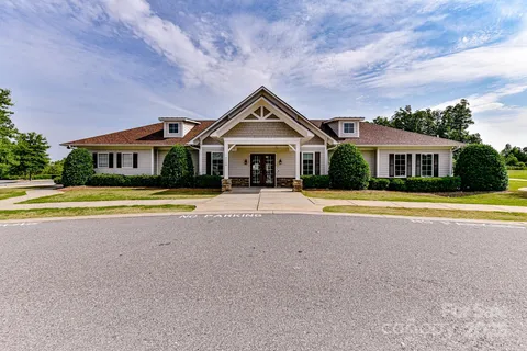 a front view of a house with swimming pool and porch