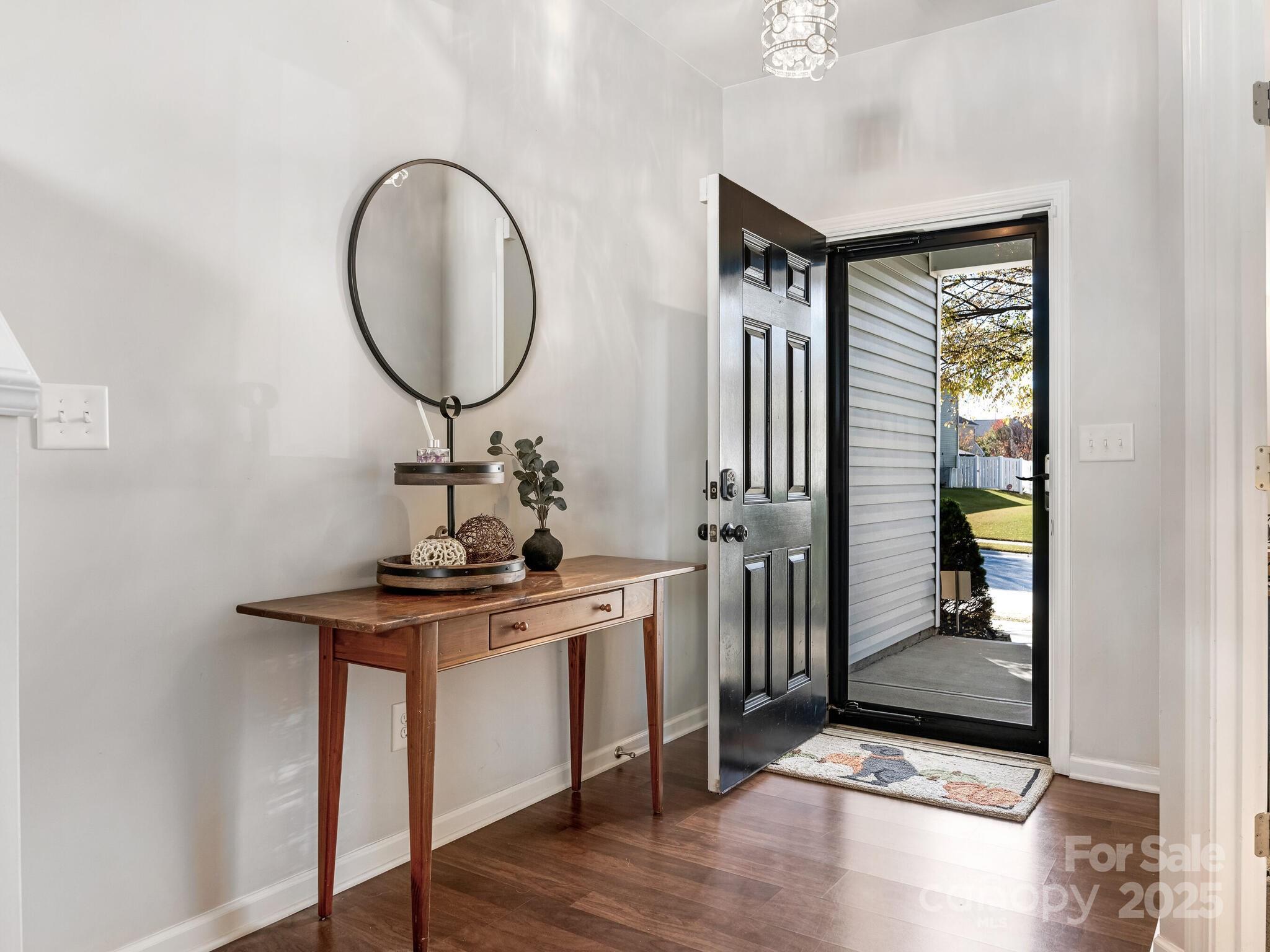 13118 Great Laurel Road Charlotte, NC 28227 - Photo 5 of 38 a view of a hallway with wooden floor and entryway
