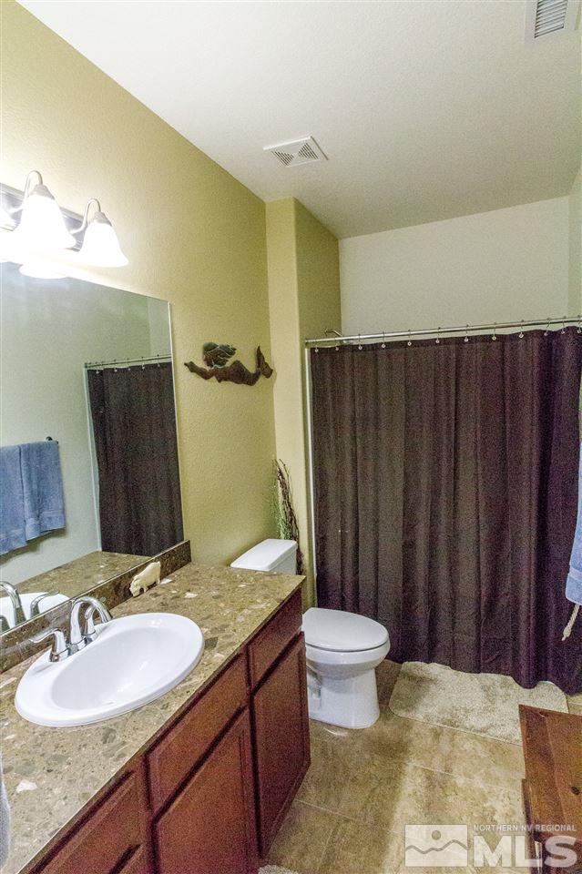 2285 Makenna Drive Reno, NV 89521 - Photo 16 of 24 a bathroom with a granite countertop sink and a mirror