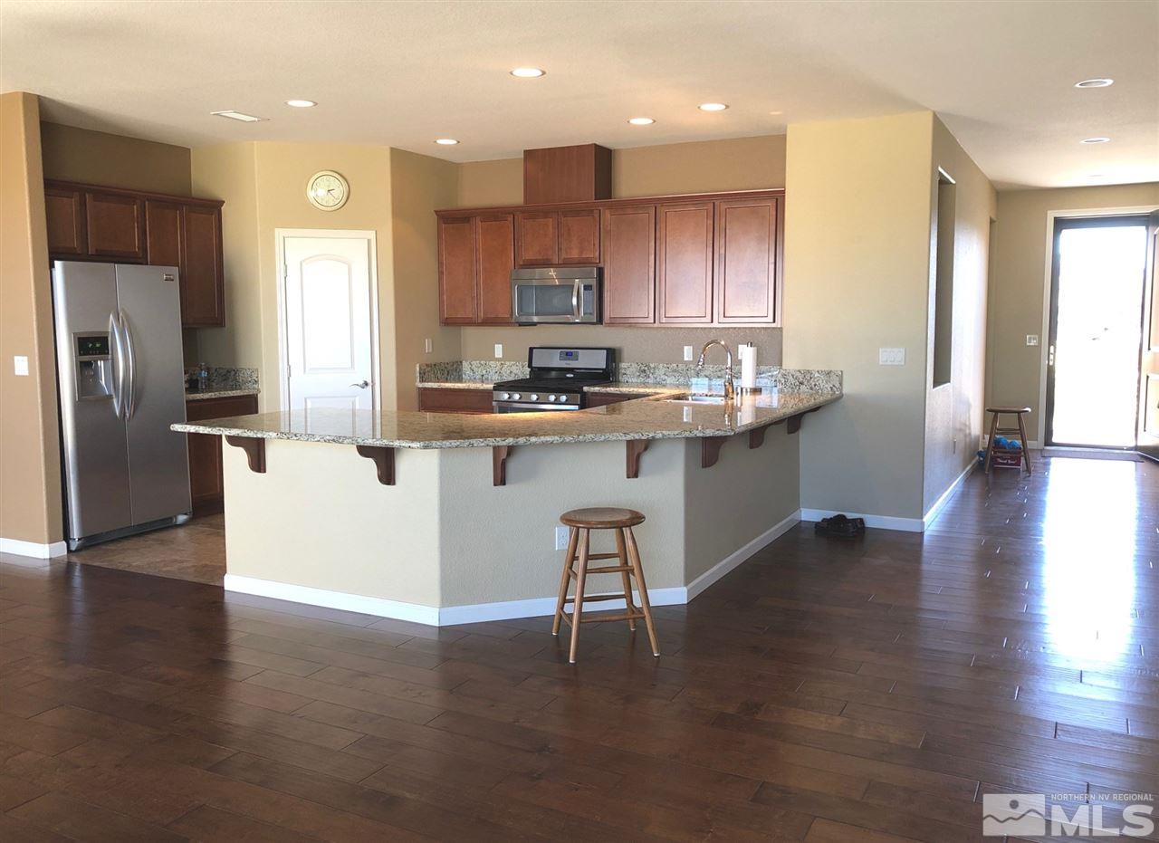 2285 Makenna Drive Reno, NV 89521 - Photo 7 of 24 a kitchen with stainless steel appliances granite countertop a stove top oven a sink and a refrigerator