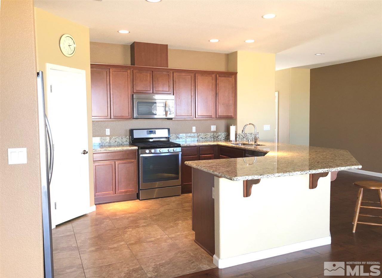 2285 Makenna Drive Reno, NV 89521 - Photo 8 of 24 a kitchen with a sink a stove and a refrigerator