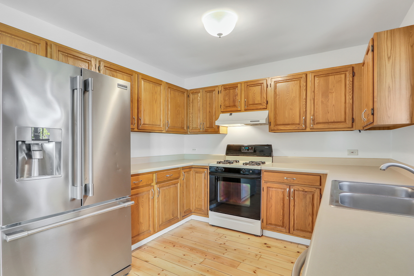 334 Concord Square Gurnee, IL 60031 - Photo 16 of 32 a kitchen with stainless steel appliances granite countertop a refrigerator sink and cabinets