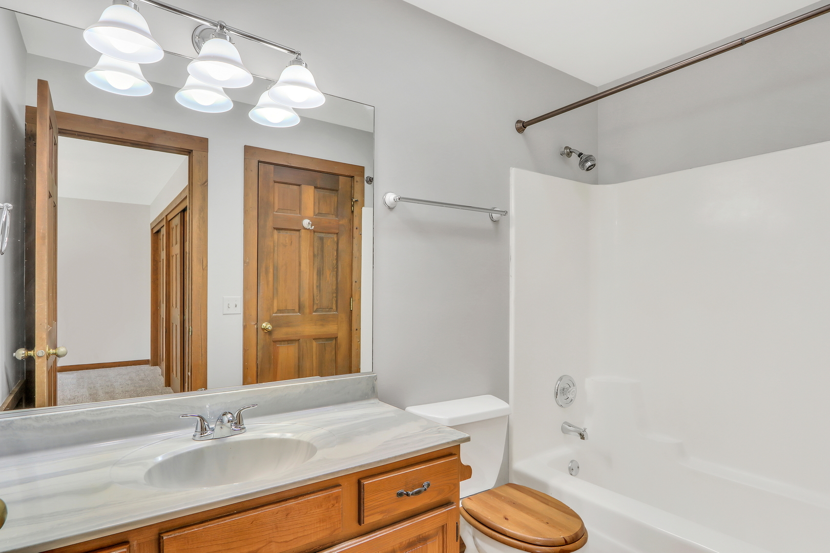 334 Concord Square Gurnee, IL 60031 - Photo 21 of 32 a bathroom with a granite countertop sink toilet a mirror a vanity and shower