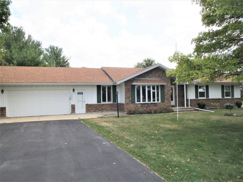 2086 Peek Home Road Dixon, IL 61021 - Photo 1 of 30 a front view of a house with a yard