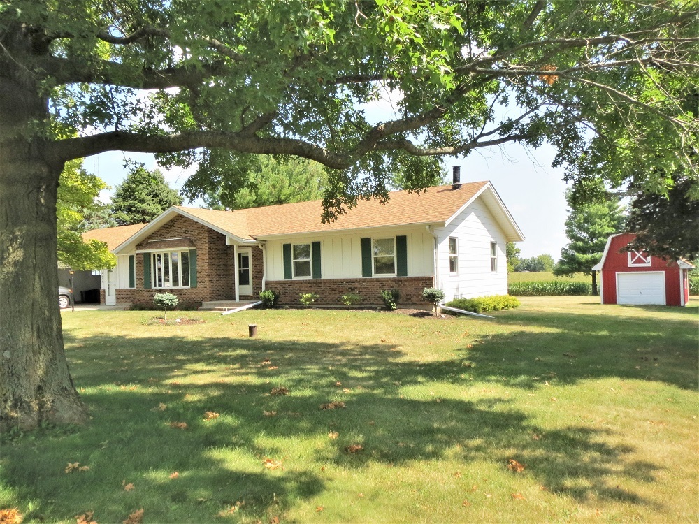 2086 Peek Home Road Dixon, IL 61021 - Photo 2 of 30 a front view of a house with a yard and trees