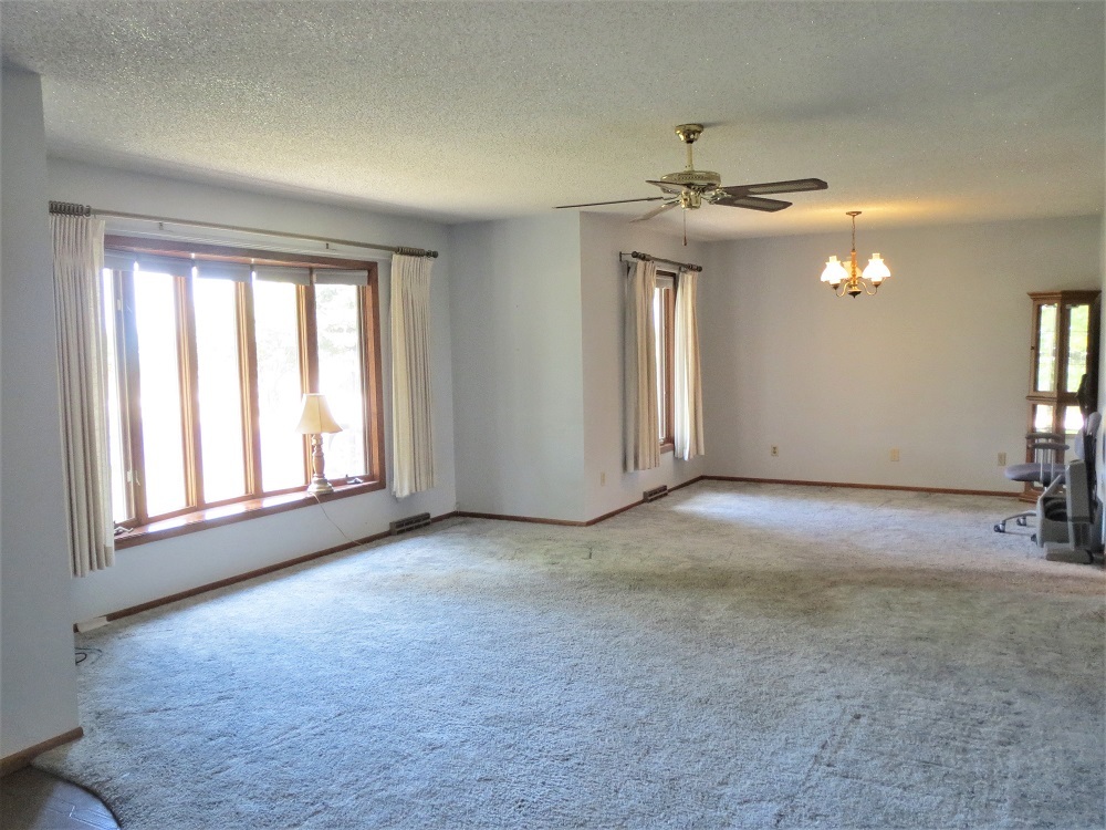 2086 Peek Home Road Dixon, IL 61021 - Photo 4 of 30 an empty room with windows and ceiling fan