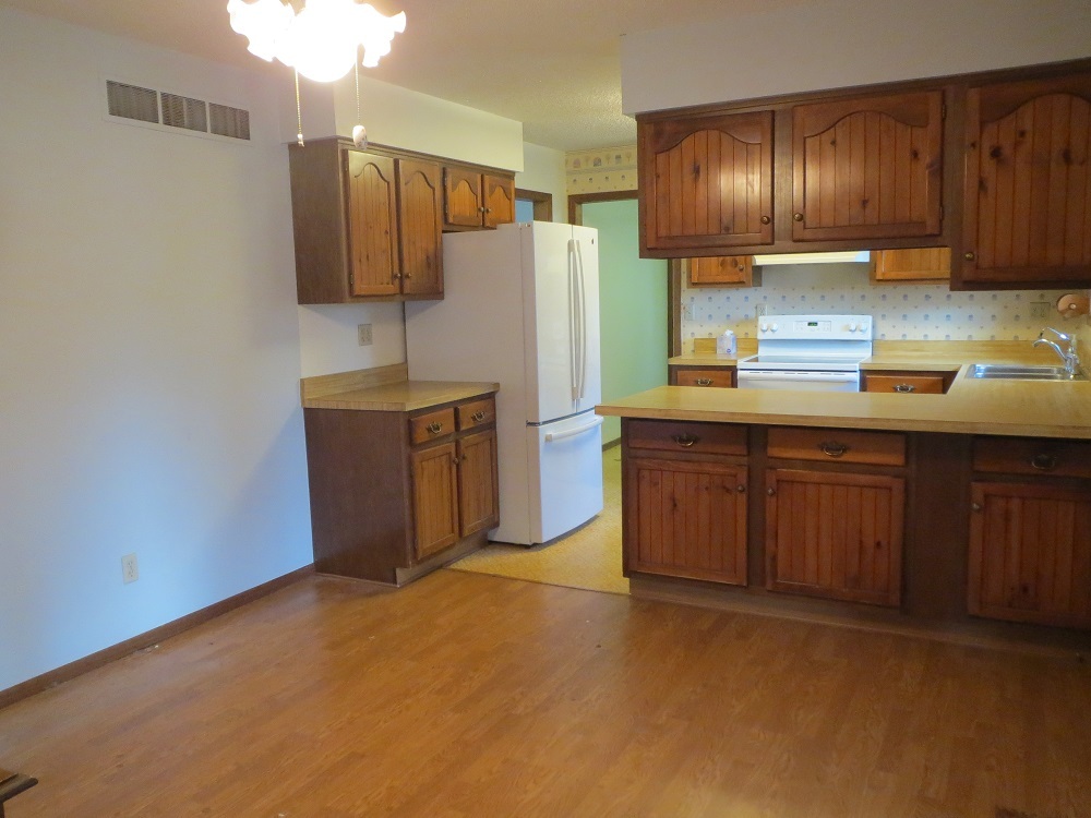 2086 Peek Home Road Dixon, IL 61021 - Photo 9 of 30 a kitchen with stainless steel appliances wooden cabinets and a sink