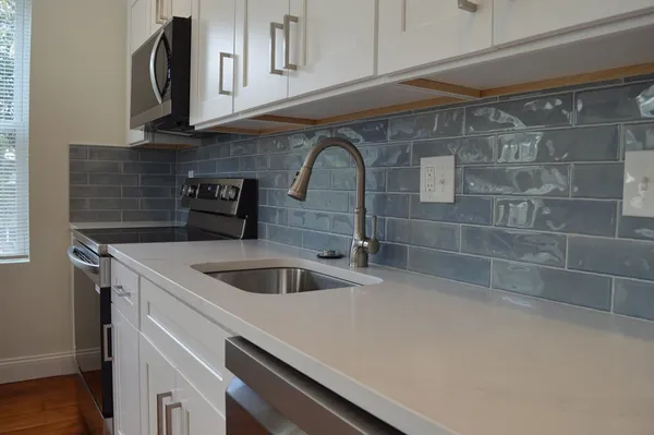 a kitchen with a sink and cabinets