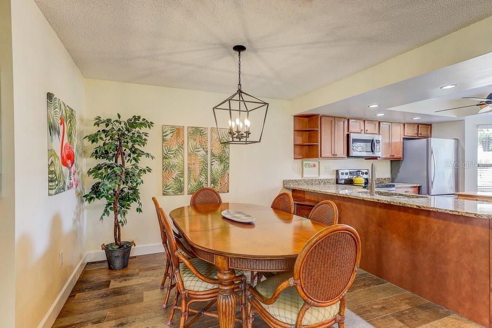 3454 Niblick Court New Port Richey, FL 34655 - Photo 17 of 54 a dining room with furniture potted plants and wooden floor