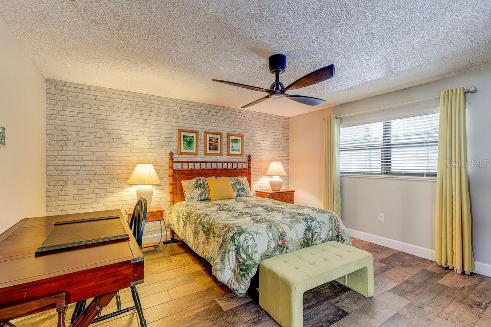 3454 Niblick Court New Port Richey, FL 34655 - Photo 26 of 54 a bedroom with a bed and a large window