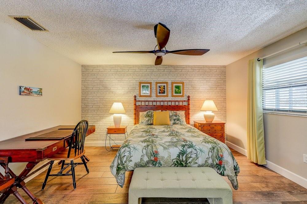 3454 Niblick Court New Port Richey, FL 34655 - Photo 27 of 54 a bedroom with a bed and wooden floor