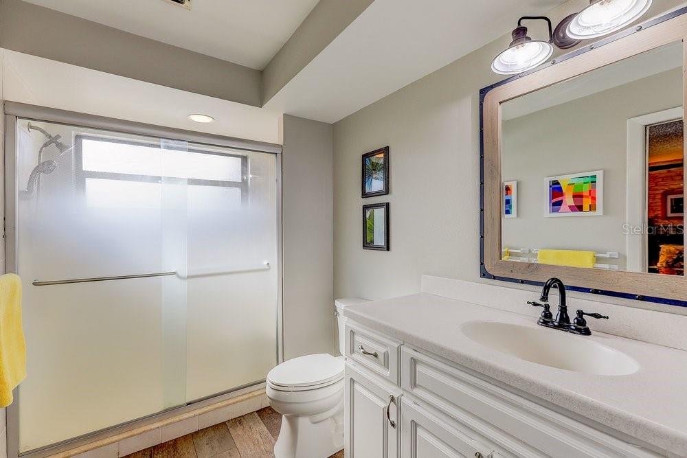 3454 Niblick Court New Port Richey, FL 34655 - Photo 30 of 54 a bathroom with a sink mirror vanity and toilet