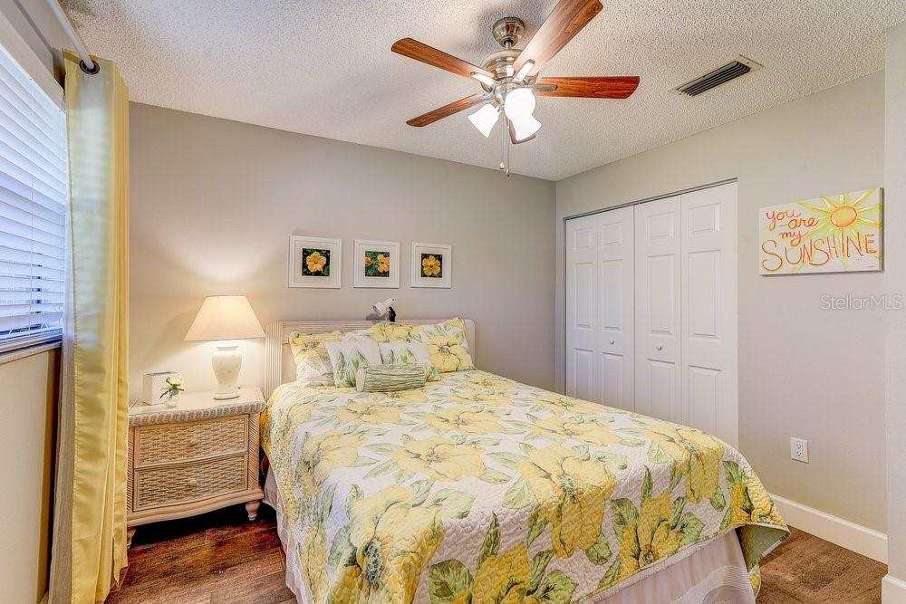 3454 Niblick Court New Port Richey, FL 34655 - Photo 32 of 54 a bedroom with a bed and a chandelier