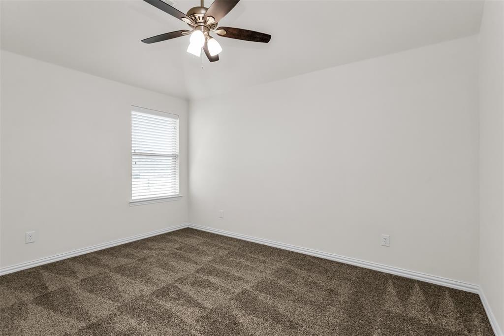 15713 Canyon Ridge Prosper, TX 75078 - Photo 30 of 38 Carpeted interior room featuring a window with horizontal blinds, white walls, and a ceiling fan with integrated lighting