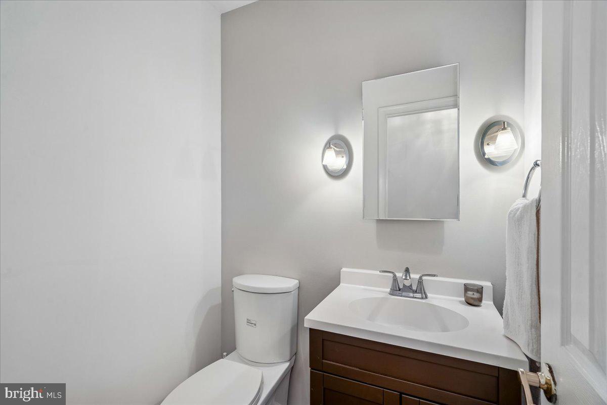 8010 Craddock Road Greenbelt, MD 20770 - Photo 15 of 49 a bathroom with a sink vanity mirror and toilet