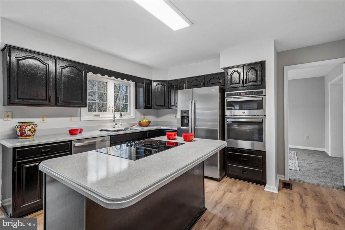 8010 Craddock Road Greenbelt, MD 20770 - Photo 16 of 49 a kitchen that has a stove and a refrigerator