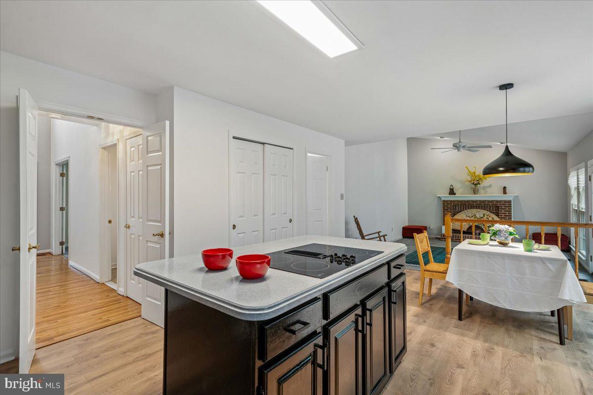 8010 Craddock Road Greenbelt, MD 20770 - Photo 17 of 49 a utility room with stainless steel appliances kitchen island a stove a refrigerator and chandelier