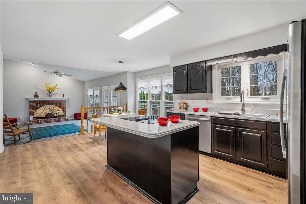 8010 Craddock Road Greenbelt, MD 20770 - Photo 19 of 49 a kitchen with kitchen island a sink stove top oven and cabinets