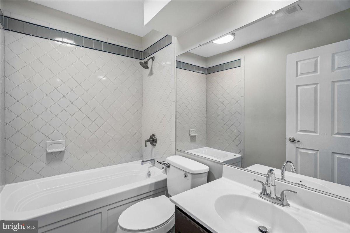 8010 Craddock Road Greenbelt, MD 20770 - Photo 37 of 49 a bathroom with a sink toilet and shower