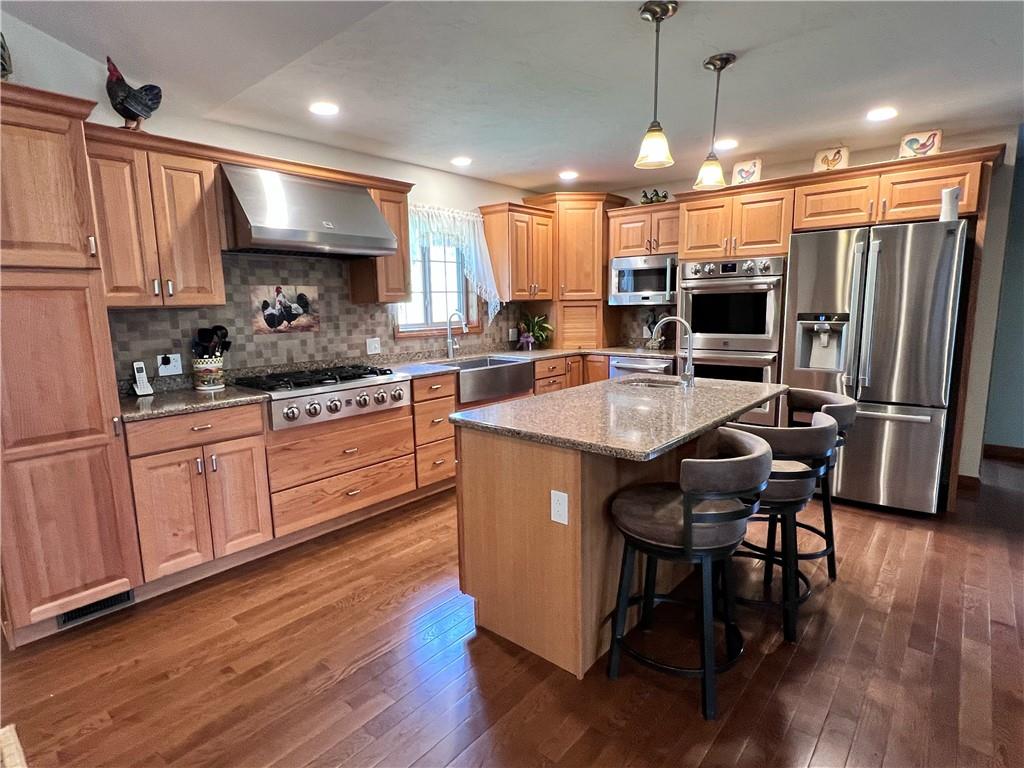 603 Lingenfelter Road Indiana, PA 15701 - Photo 2 of 17 a kitchen with stainless steel appliances granite countertop a sink a stove a refrigerator cabinets and wooden floor