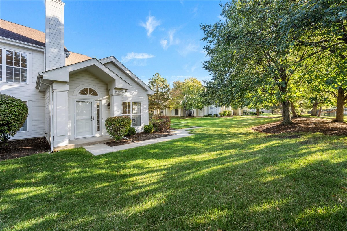 1320 Georgetown Drive Batavia, IL 60510 - Photo 2 of 21 a front view of a house with a garden