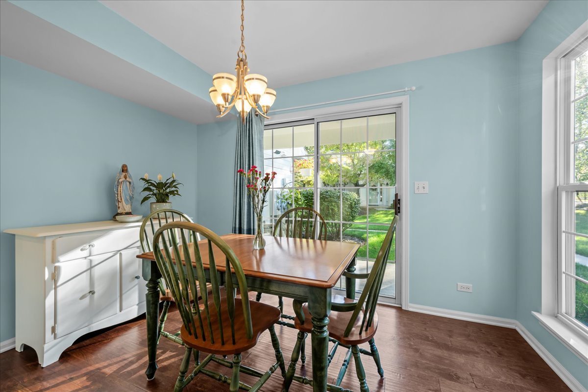 1320 Georgetown Drive Batavia, IL 60510 - Photo 10 of 21 a view of a dining room with furniture a chandelier and wooden floor