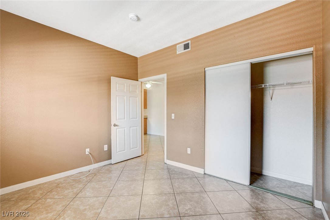 4730 East Craig Road, Unit 1005 Las Vegas, NV 89115 - Photo 21 of 45 Unfurnished bedroom featuring a closet and light tile patterned floors