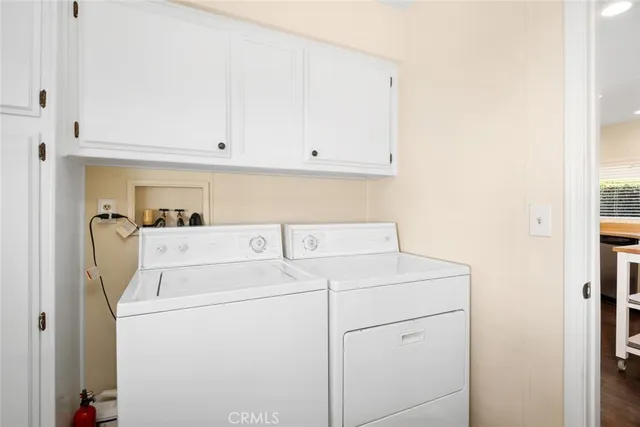 a view of washer and dryer with kitchen in the background