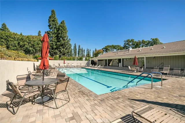 a view of a house with backyard and sitting area