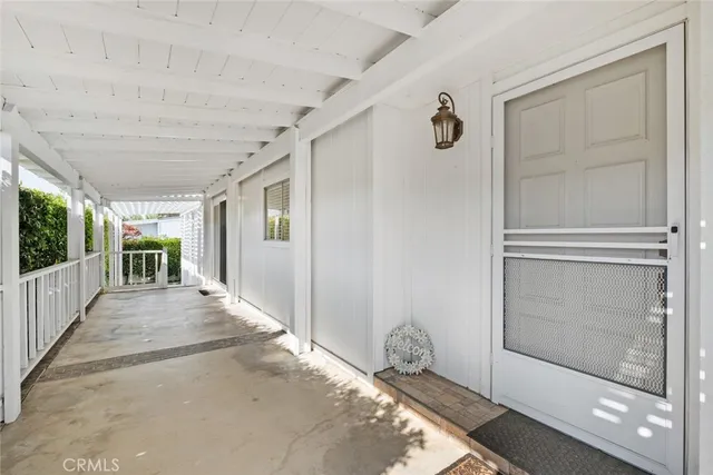 a view of a hallway with wooden floor and windows