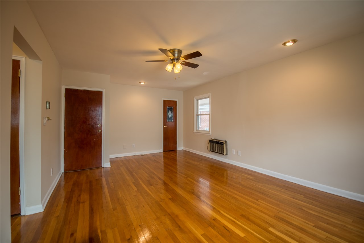 715 Broad Avenue, Unit 3A Ridgefield, NJ 07657 - Photo 1 of 1 wooden floor in an empty room with a window
