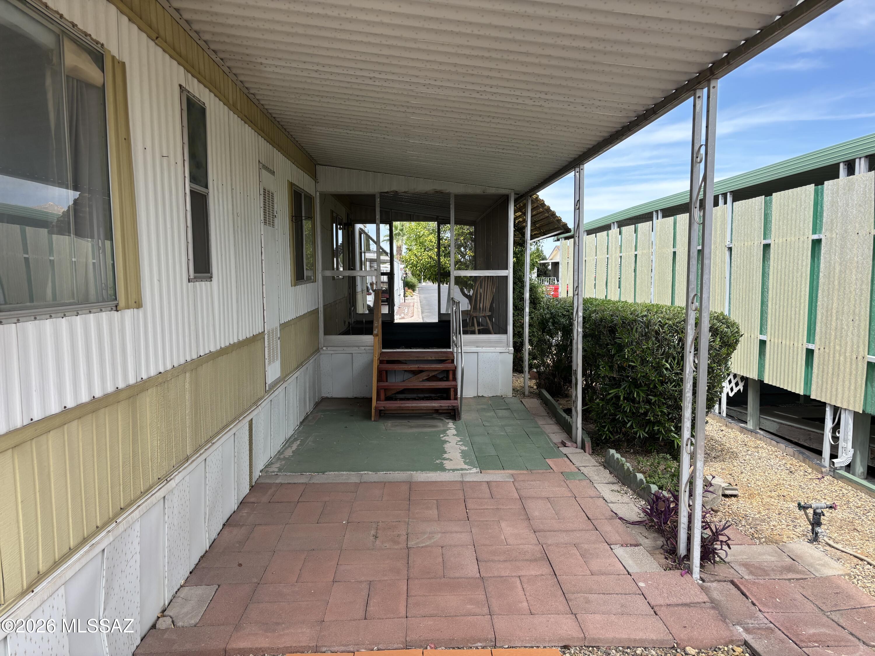 4550 North Flowing Wells Road, Unit 65 Tucson, AZ 85705 - Photo 39 of 50 a view of a porch with wooden floor and stairs