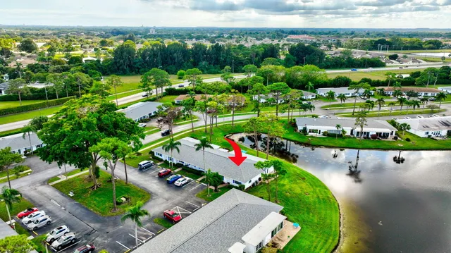 an aerial view of a tennis ground and a cars park