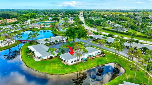 an aerial view of a tennis ground with a large pool