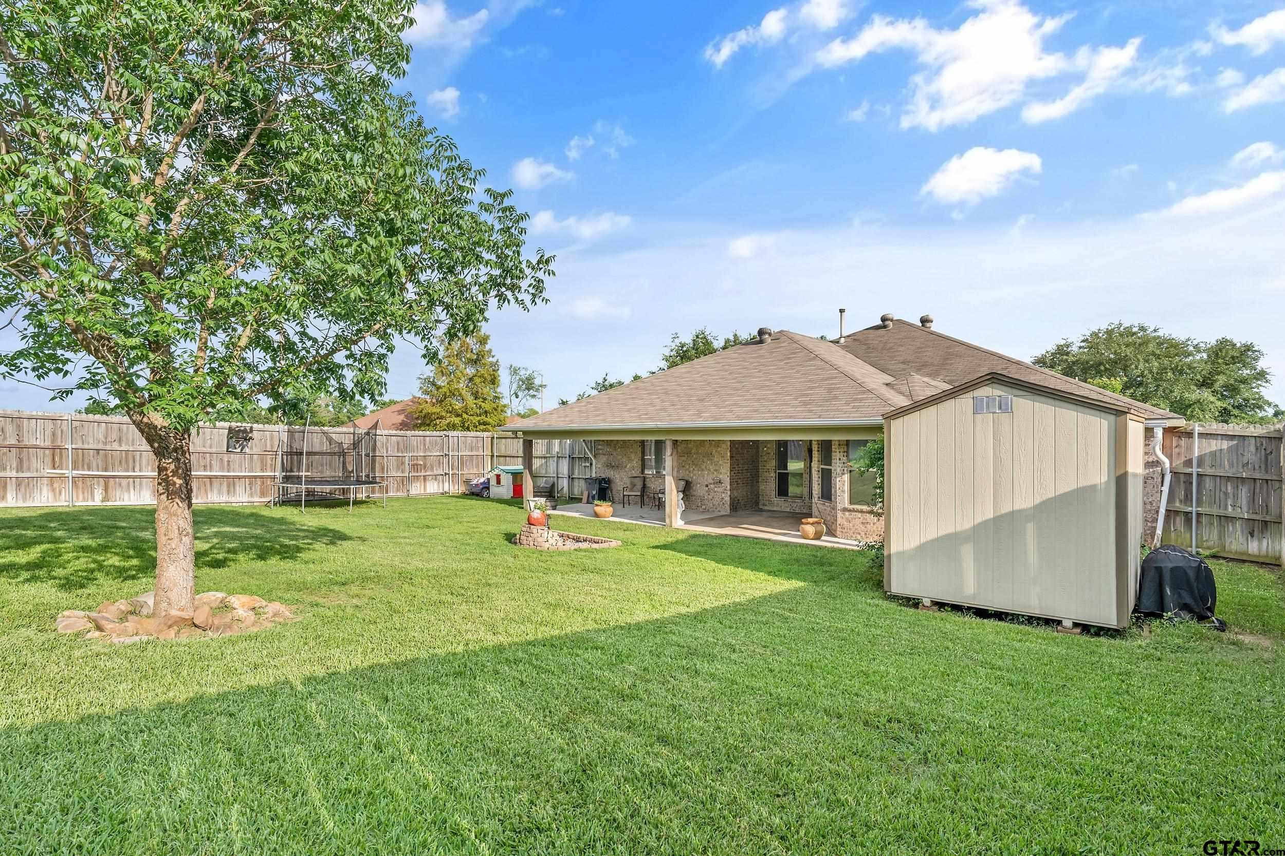10820 Cactus Trail Flint, TX 75762 - Photo 28 of 29 a view of a house with a yard and sitting area