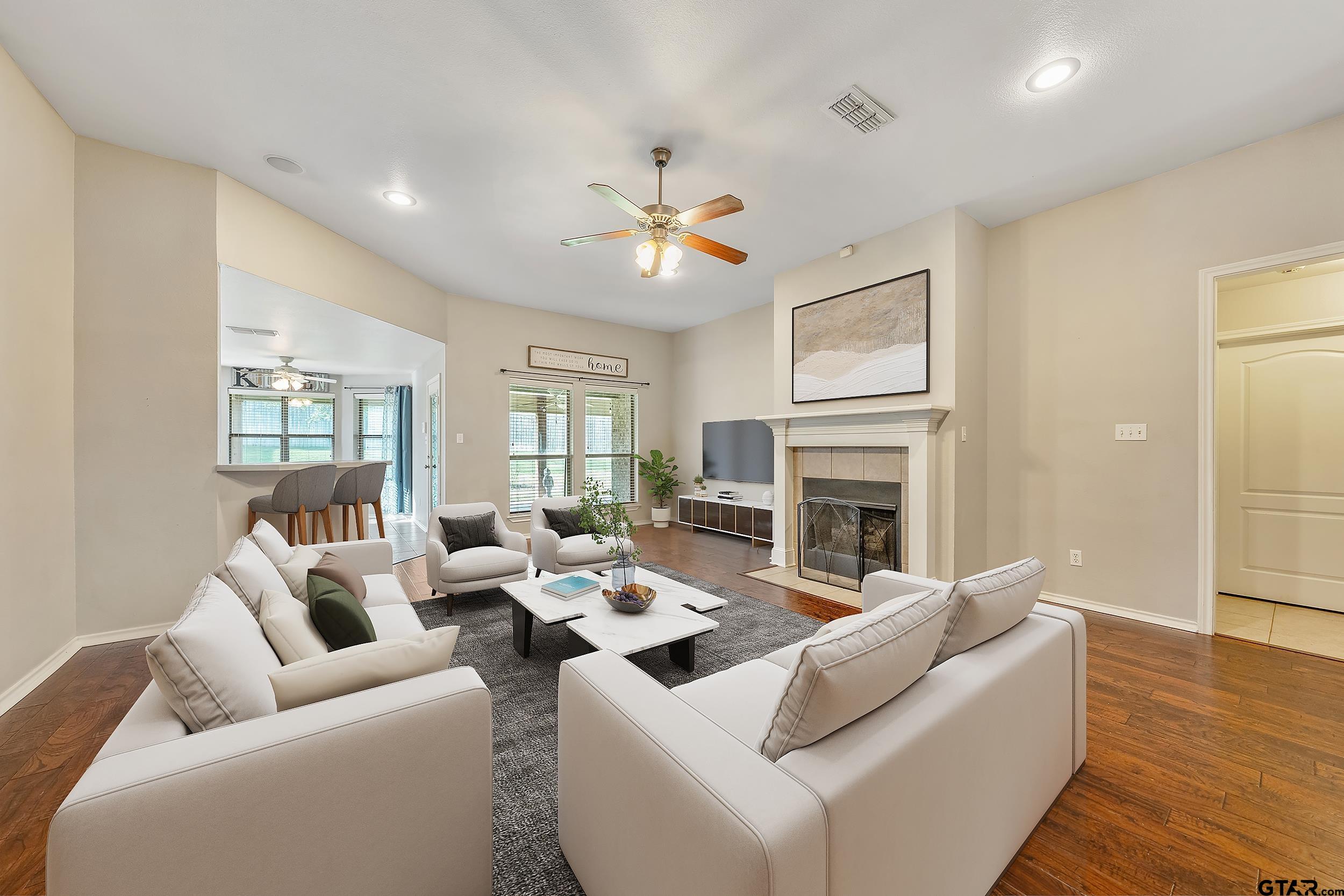 10820 Cactus Trail Flint, TX 75762 - Photo 4 of 29 a living room with furniture a fireplace and a ceiling fan