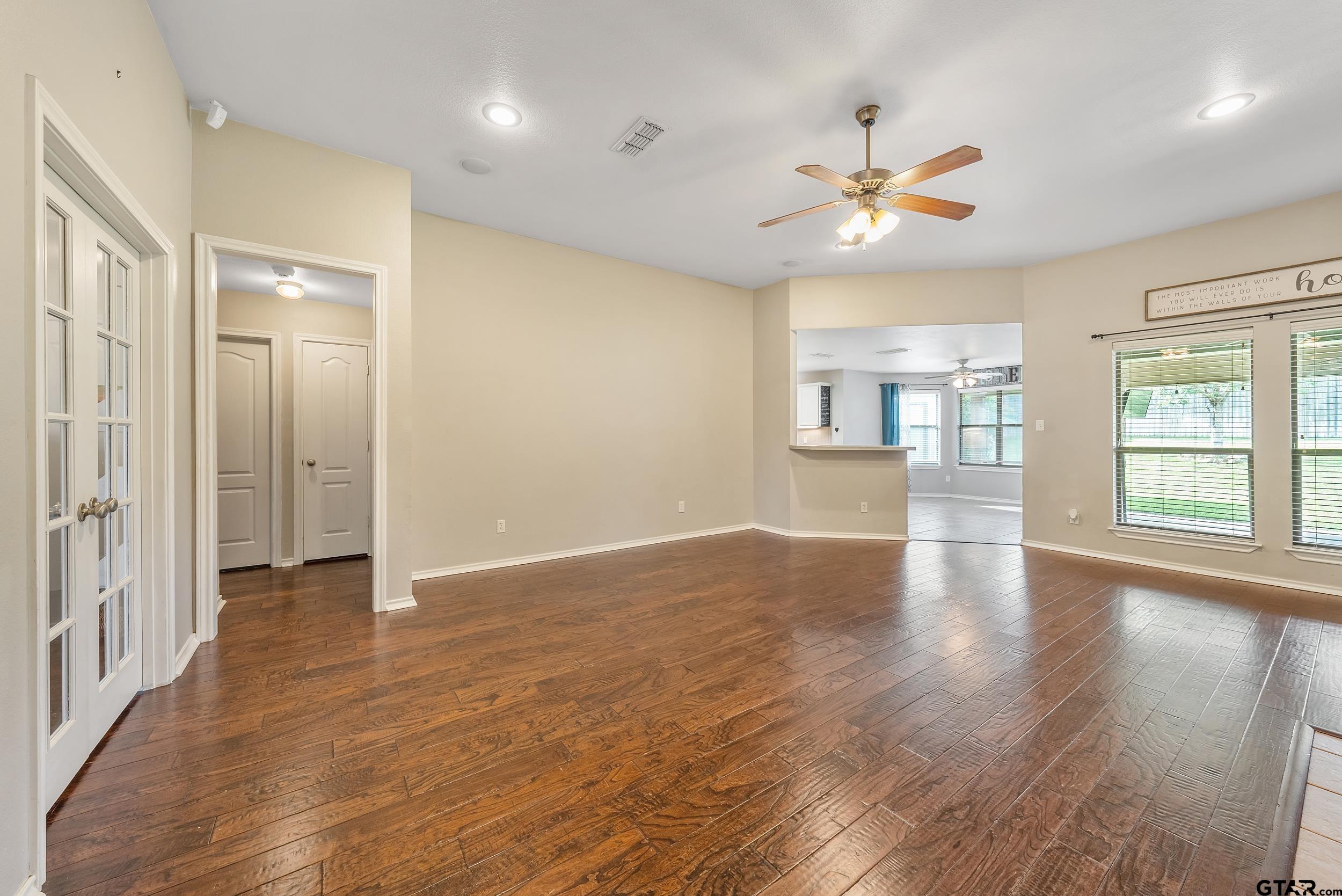 10820 Cactus Trail Flint, TX 75762 - Photo 6 of 29 a view of an empty room with a window and wooden floor