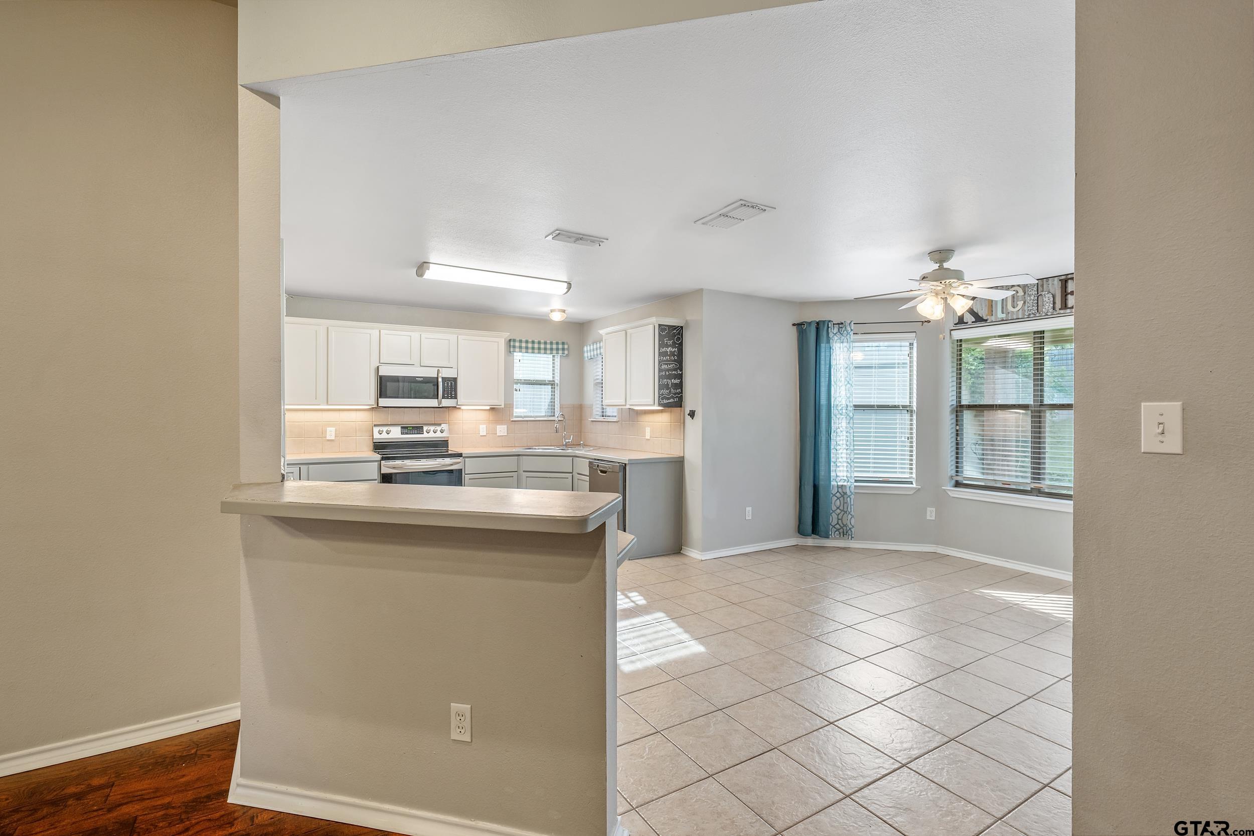 10820 Cactus Trail Flint, TX 75762 - Photo 7 of 29 a kitchen with stainless steel appliances granite countertop a sink and cabinets