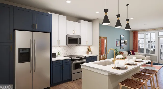 a kitchen with stainless steel appliances kitchen island a table chairs and a refrigerator